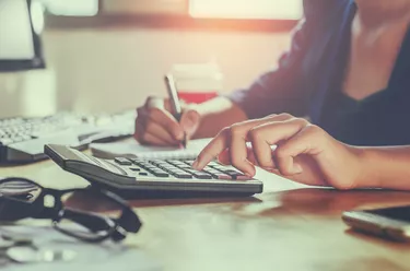 businessman working on desk office using calculator business financial accounting concept