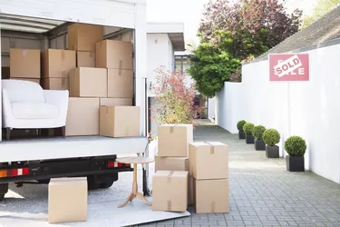 Boxes on ground near moving van