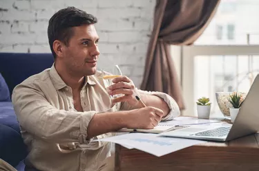 Man with a pen at his laptop