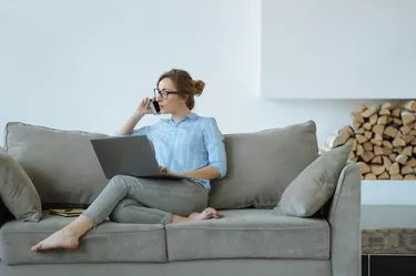 Woman working on a couch