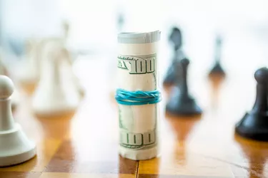 What Is Risk Preference?                           Closeup of twisted dollars lying on wooden chess board