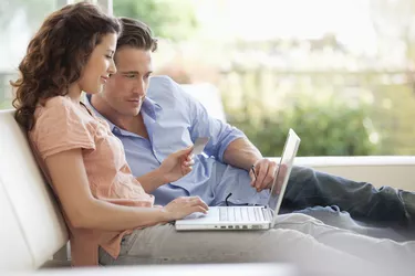 Couple with credit card and laptop