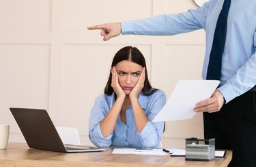 Boss Firing Woman Worker Sitting In Modern Office, Cropped