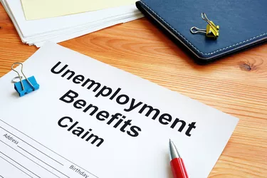 Unemployment benefits claim and stack of documents.