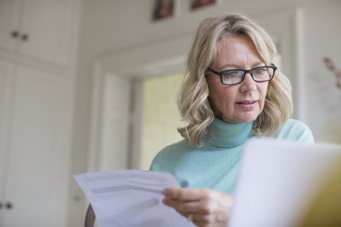 Mature female freelancer working at laptop at home