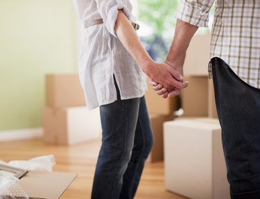 Couple holding hands in new house
