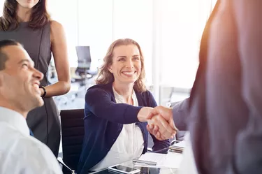 Mature businesswoman shaking hands