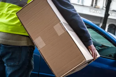 Amazon Prime Delivery Man During A Work Shift. Amazon Is An Electronic Online Commerce Company