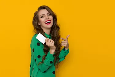 Laughing Woman Wearing Green Shirt Holds White Card