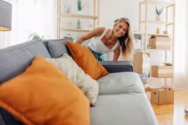 woman moving a couch