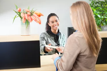 Bank Teller Helping Customer in Retail Banking Window Counter