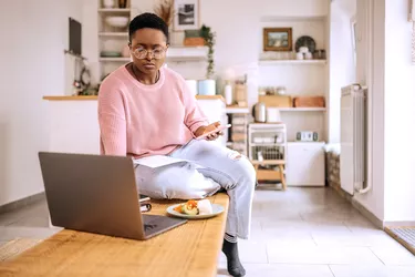 Young beautiful woman going over finances at home