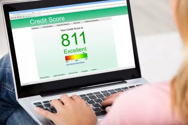 Woman Checking Credit Score Online On Laptop