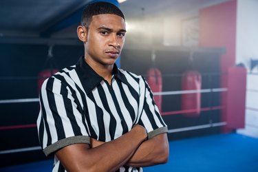 Portrait of confident male referee with arms crossed