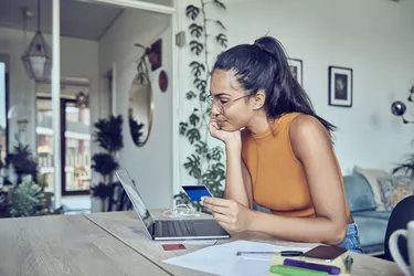 Beautiful woman doing finances at home