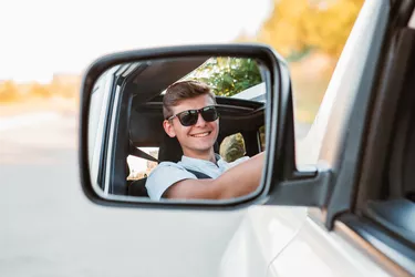 young handsome confident man driving car