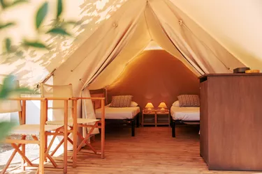 Glamping tent with cozy interior on a sunny day. Luxury camping tent for outdoor summer holiday and vacation lifestyle concept