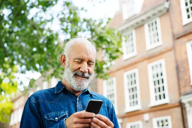 Man using smart phone outside