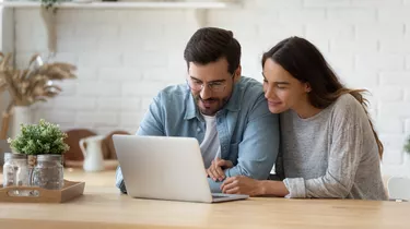 Couple checking property listings.