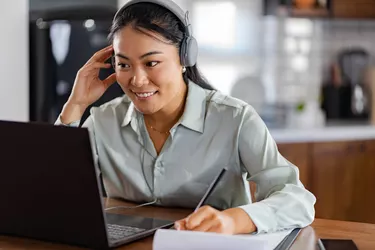 Young Asian woman attending online foreign language classes