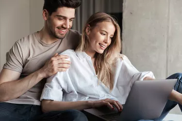 Young cute happy loving couple in home