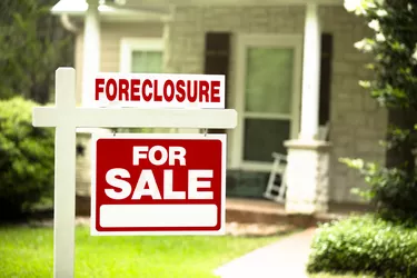 Foreclosure, house for sale sign. Front yard of home. Nobody.