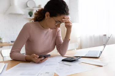 Unhappy woman have financial problems calculating budget