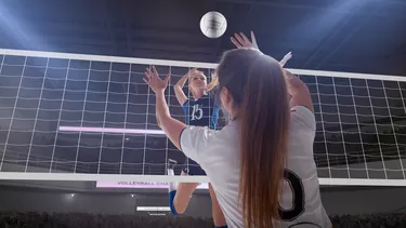 Two women playing professional volleyball