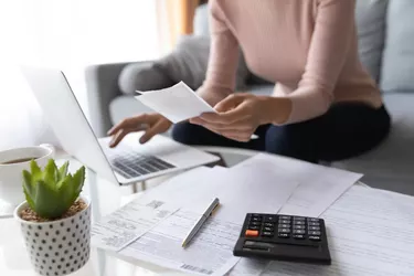 Close up of woman pay bills taxes on laptop