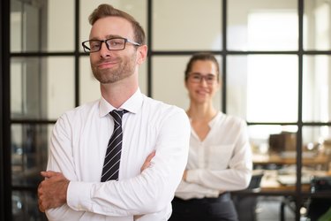 Confident middle-aged business man posing in office