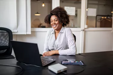 Businessman sitting in office smiling during a video call