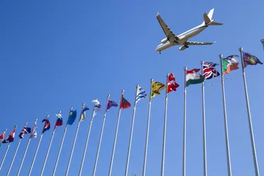 Airplane flying over the national flags