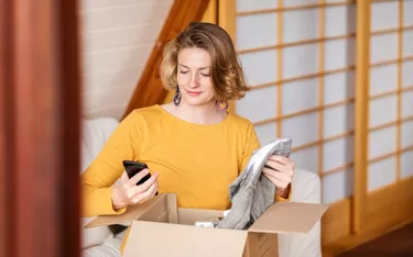 Woman checking the online delivered package at home
