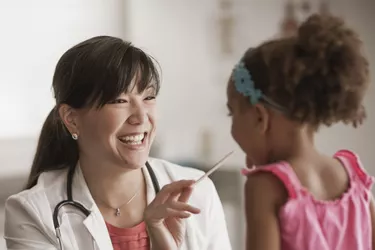 Girl having checkup in doctor's office