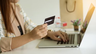 Online holiday shopping ideas with pay credit card David via laptop.