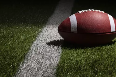 Close-Up Of Red Football On Grassland