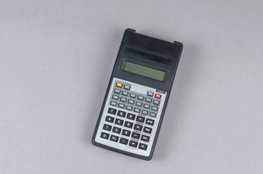 Scientific Calculator against gray background. An electronic com