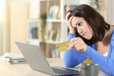 Worried woman with bank card