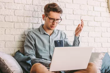 Confused businessman hipster freelancer feel puzzled while work at home