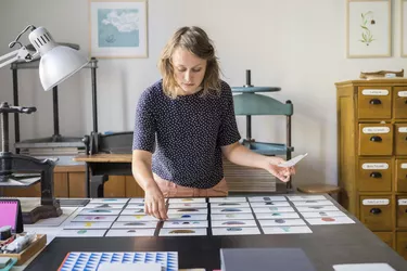 Female designer checking photos of ceramics