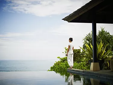 Woman standing at edge of infinity pool