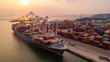 Container ship in export and import business and logistics. Shipping cargo to harbor by crane. Water transport International. Aerial view and top view.