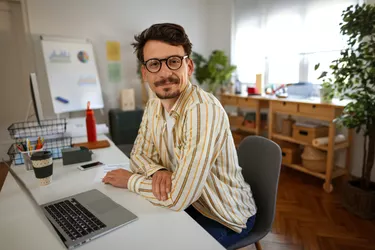 Portrait of casually clothed handsome businessman in home office