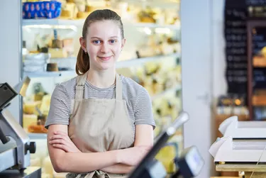 Portrait Ot Teenage Girl Working In Delicatessen Food Shop As Job Experience