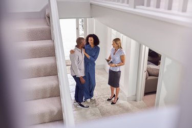 Couple Viewing Potential New Home With Female Realtor