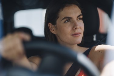 Thoughtful woman driving car