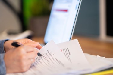 Closeup of woman filling out her taxes