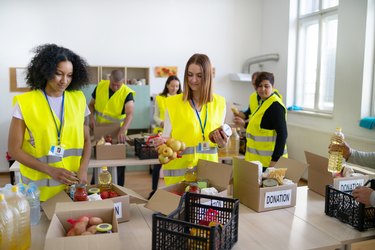 Charity workers packing groceries into donation boxes for handing out