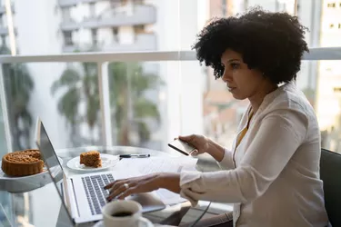 Mature woman using laptop working at home