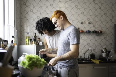 Gay couple preparing the meal in the kitchen